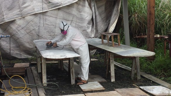 Scott sanding boards in the mud pit, I mean work shop