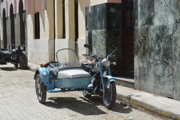 Along with all the classic 1950s American cars are lots of 19? motorcycles with sidecars