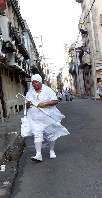 Initiates in the Santería religion are required to wear white clothing for a year, and they always carry a white umbrella.