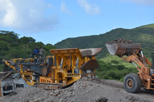 breaking up large volcanic rocks to produce and sell cement.